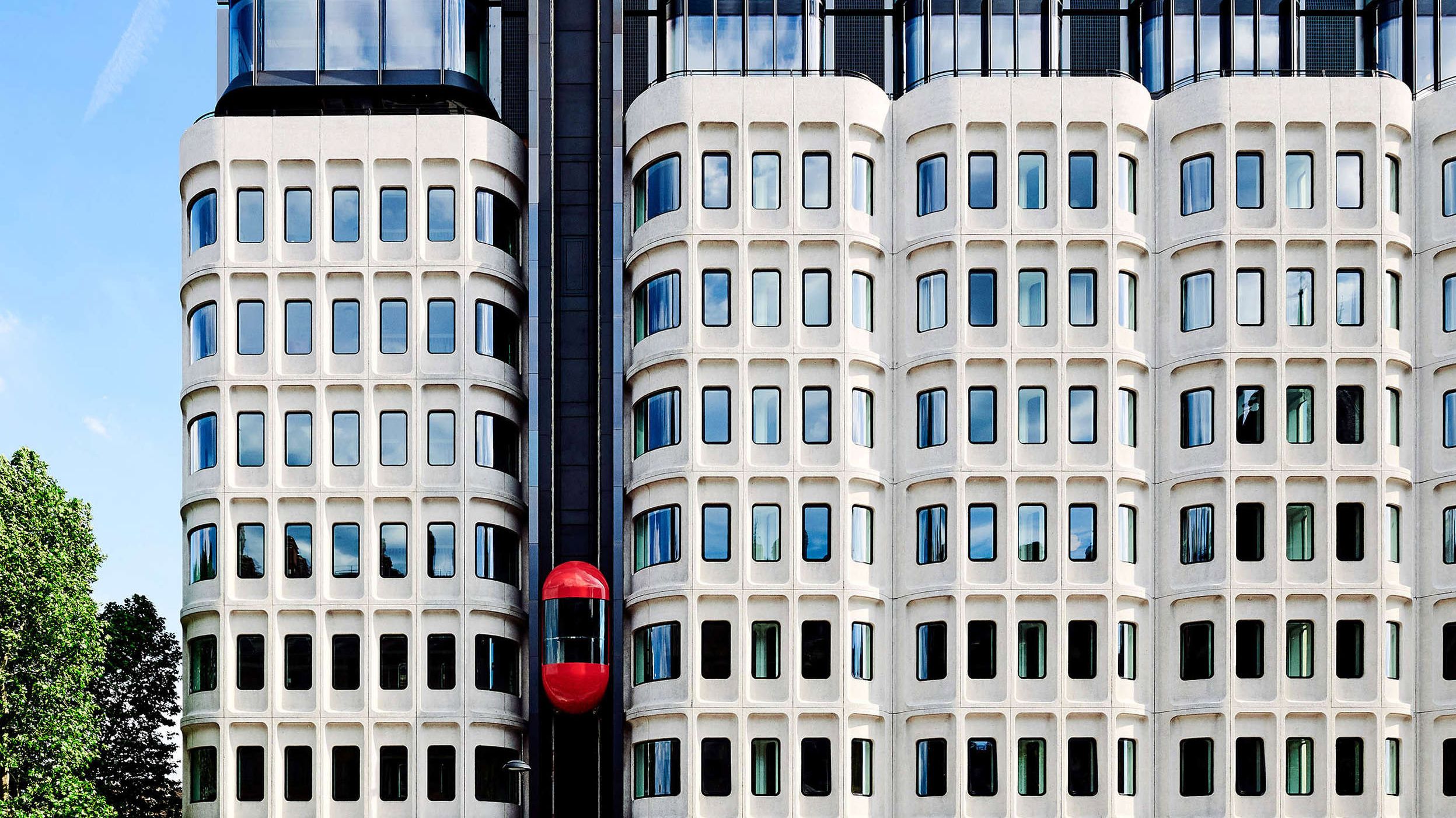 Brutalist exterior and red lift at The Standard London